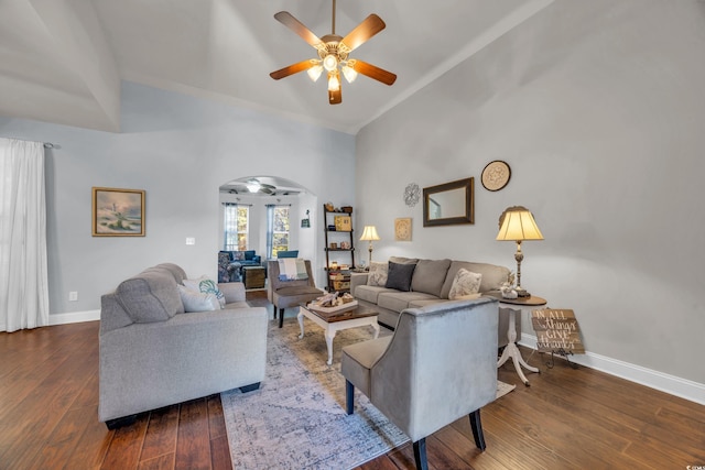 living room with dark hardwood / wood-style floors, ceiling fan, and high vaulted ceiling