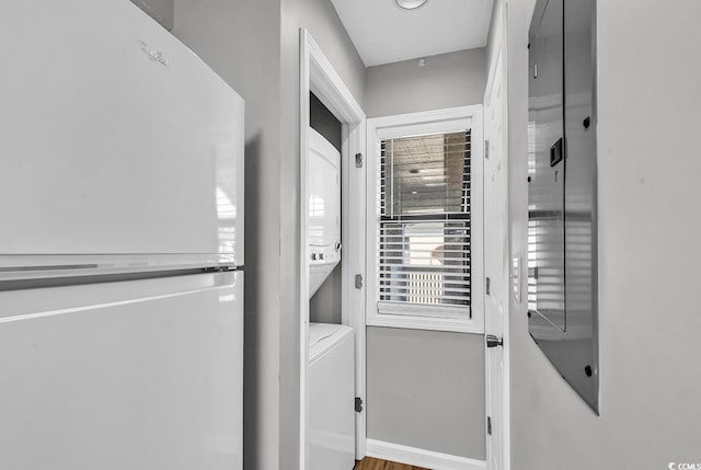 clothes washing area with stacked washer and dryer