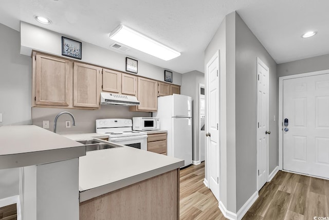 4103 Pinehurst Cir Unit Bb-14, Little River, SC 29566 - kitchen featuring white appliances, under cabinet range hood, light brown cabinetry, light wood finished floors, and a peninsula