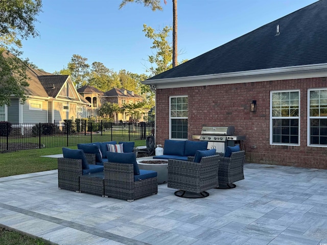 view of patio with a grill and an outdoor living space with a fire pit