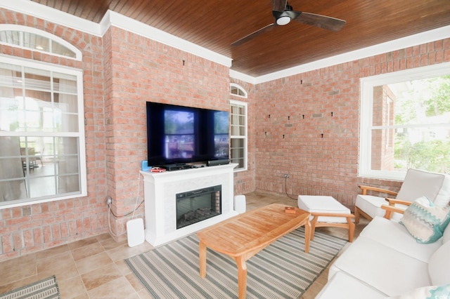 tiled living room with ceiling fan, wood ceiling, a fireplace, and brick wall