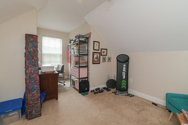 carpeted office space with vaulted ceiling