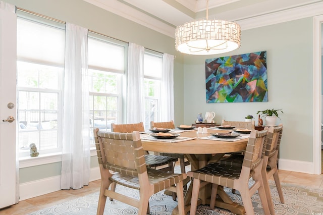 dining space with light tile patterned floors and ornamental molding