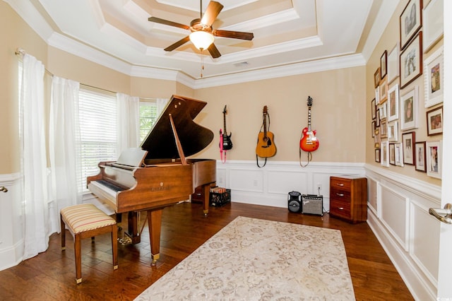 misc room with dark hardwood / wood-style floors, a tray ceiling, and crown molding