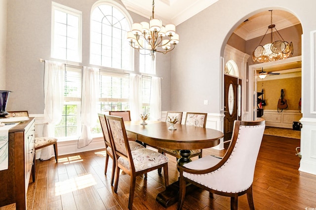 dining space featuring ceiling fan with notable chandelier, dark hardwood / wood-style floors, and crown molding