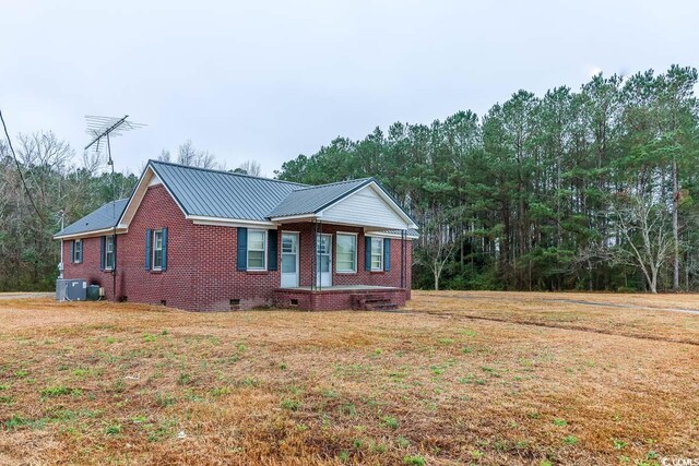 view of front facade with central AC unit and a front yard