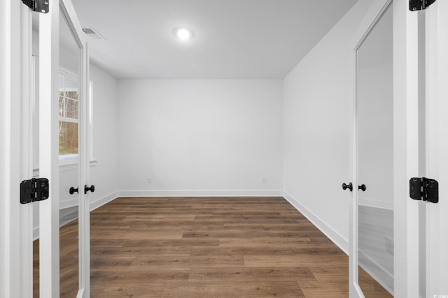 unfurnished room featuring dark hardwood / wood-style floors and french doors