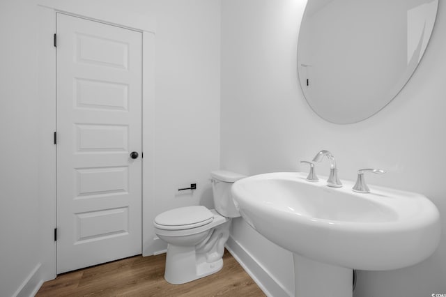 bathroom featuring sink, toilet, and hardwood / wood-style floors