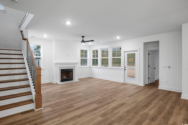 unfurnished living room featuring hardwood / wood-style floors and ceiling fan