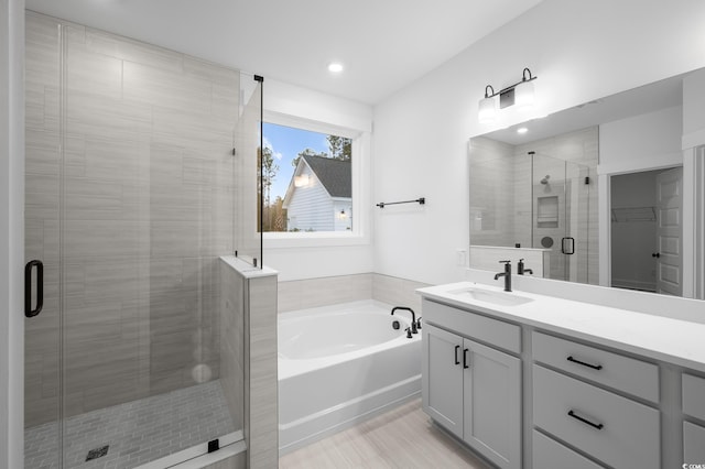 bathroom with vanity and separate shower and tub