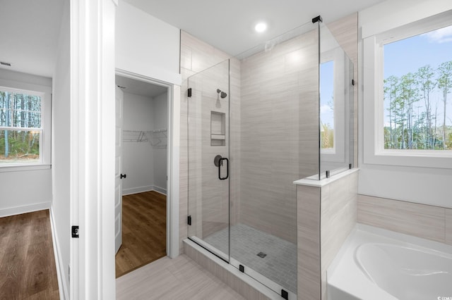 bathroom with separate shower and tub