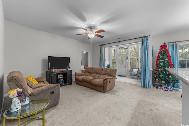 carpeted living room featuring ceiling fan