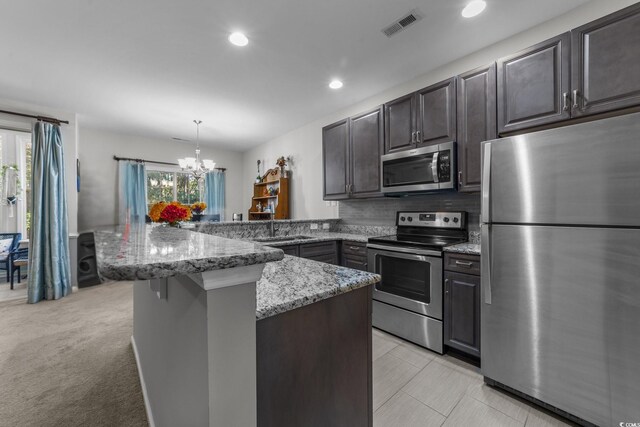 4818 Innisbrook Ct Unit 603, Myrtle Beach, SC 29579 - kitchen with a notable chandelier, light stone counters, a peninsula, stainless steel appliances, and visible vents