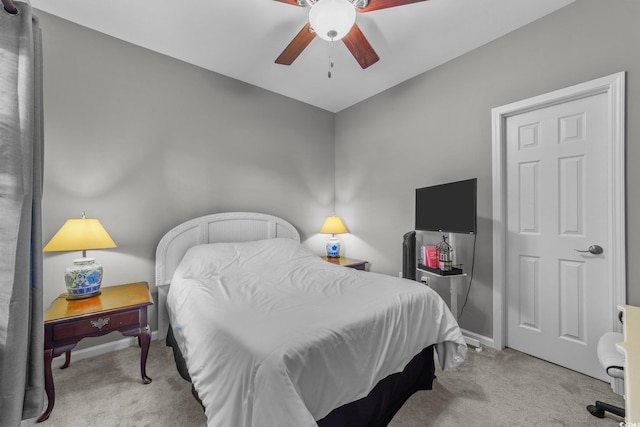 bedroom with light carpet and ceiling fan