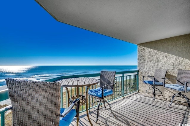 balcony featuring a water view and a beach view