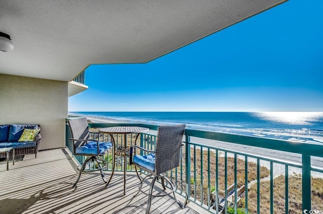 balcony with a water view and a beach view