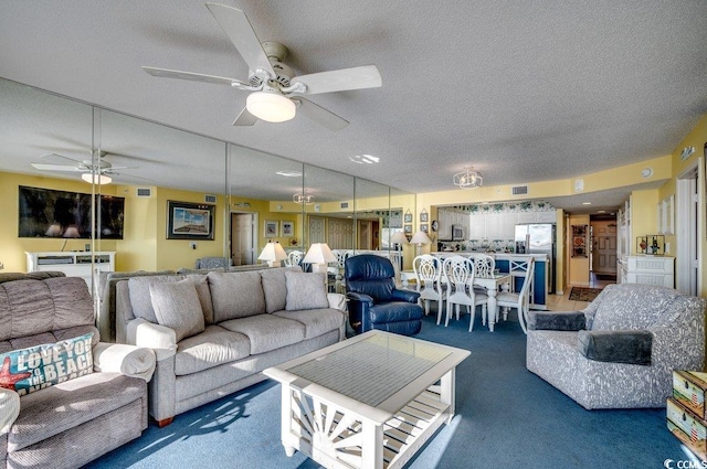 living room featuring dark colored carpet, a textured ceiling, and ceiling fan