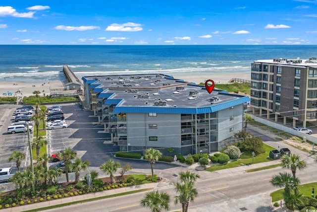 drone / aerial view with a beach view and a water view