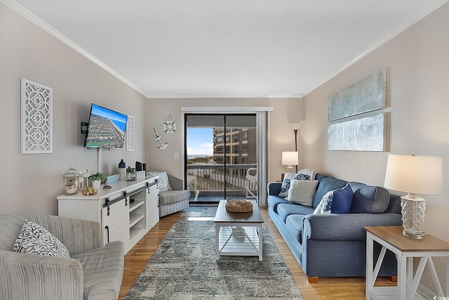 living room featuring a wealth of natural light, crown molding, and hardwood / wood-style flooring