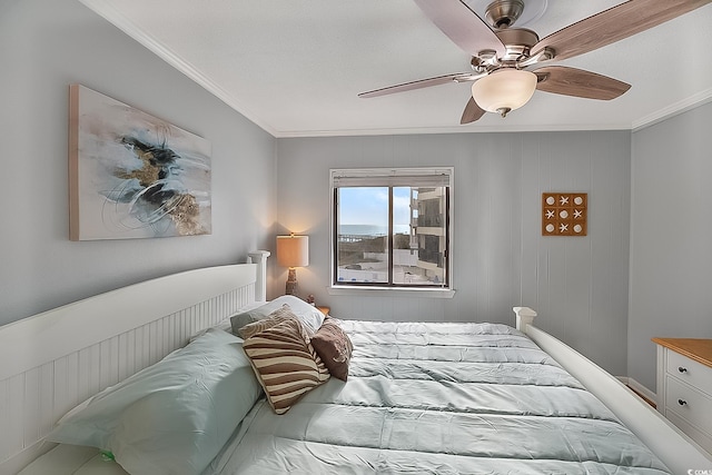 bedroom featuring ceiling fan, wood walls, and ornamental molding