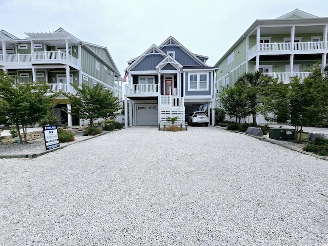 beach home featuring driveway, a carport, a porch, and stairway