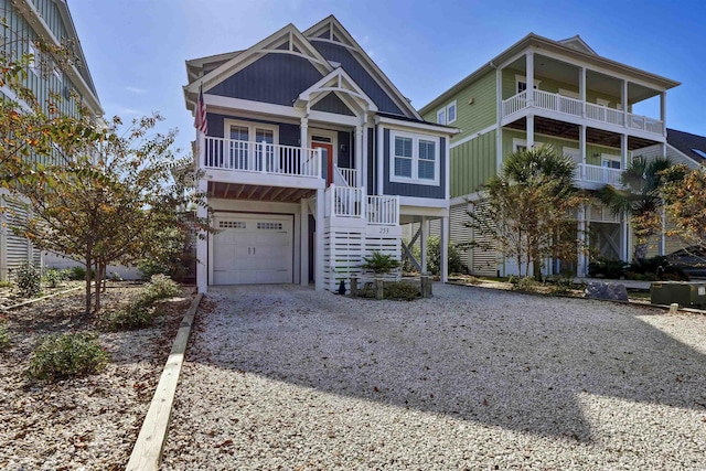 coastal inspired home featuring an attached garage, driveway, and stairway