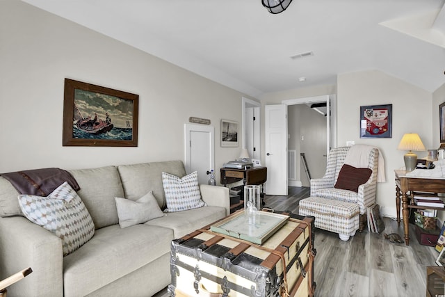 living area with wood finished floors and visible vents