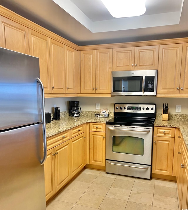 9994 Beach Club Dr Unit 1806, Myrtle Beach, SC 29572 - kitchen with stainless steel appliances, a raised ceiling, and light brown cabinetry