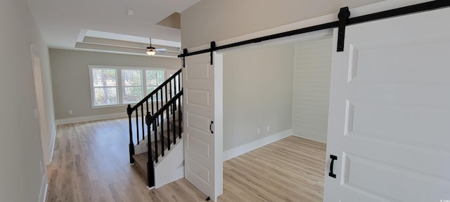 stairway featuring ceiling fan and hardwood / wood-style floors