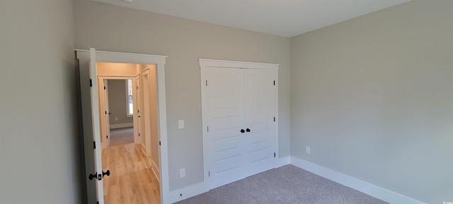 unfurnished bedroom featuring carpet floors and a closet