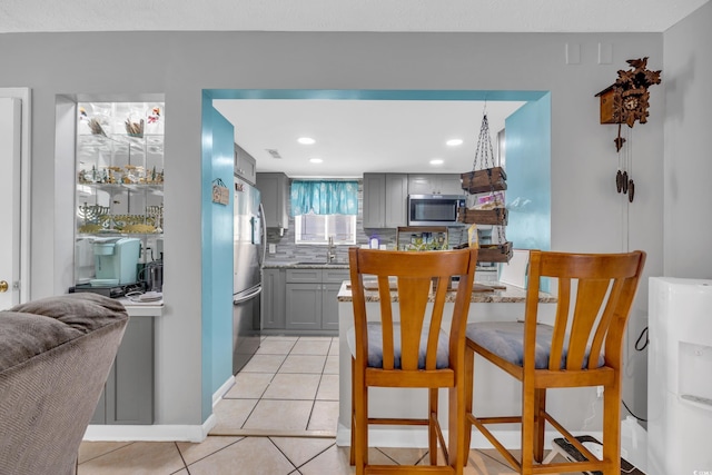 tiled dining area featuring sink