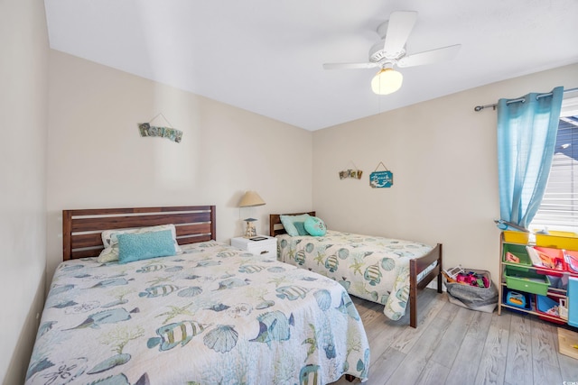 bedroom with ceiling fan and light wood-type flooring