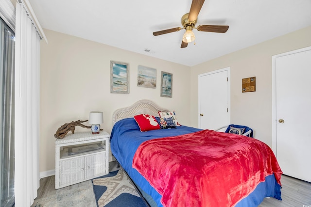 bedroom featuring light wood-type flooring and ceiling fan