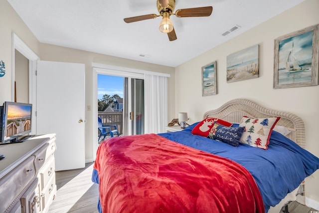 bedroom featuring access to outside, ceiling fan, and hardwood / wood-style flooring