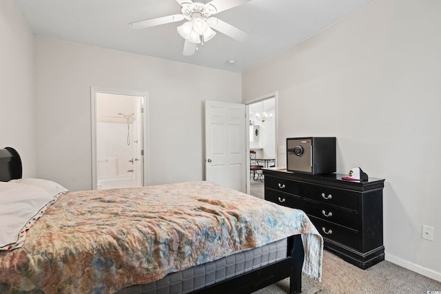 bedroom featuring ceiling fan, light colored carpet, and connected bathroom