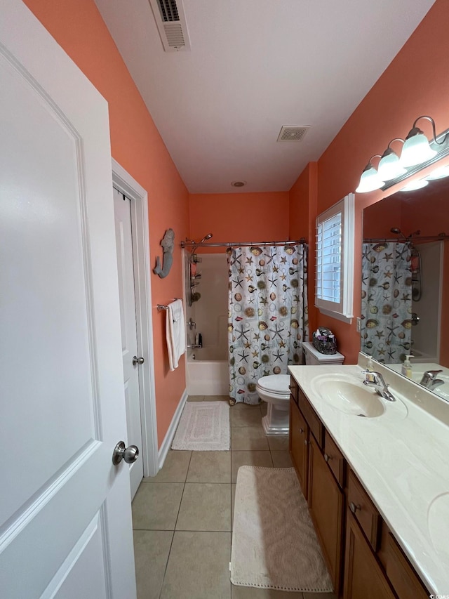 bedroom with connected bathroom, a tray ceiling, ceiling fan, and ornamental molding