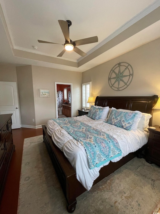 bedroom with a raised ceiling, ceiling fan, and ornamental molding