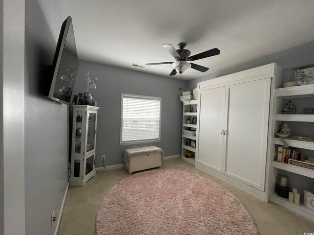 bedroom featuring ceiling fan and light carpet