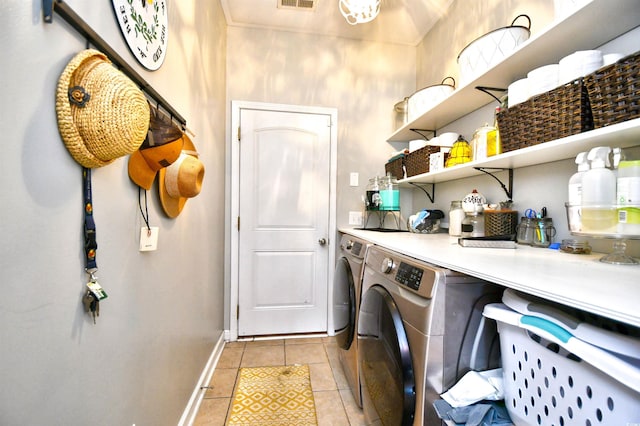 laundry area featuring light tile patterned flooring and washing machine and clothes dryer