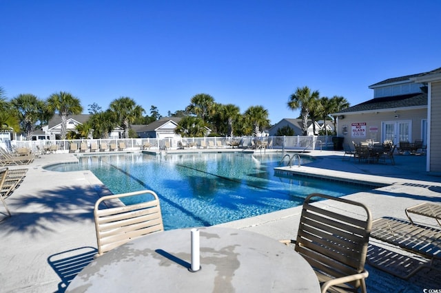 view of pool with french doors and a patio area