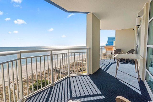 balcony with a water view and a beach view