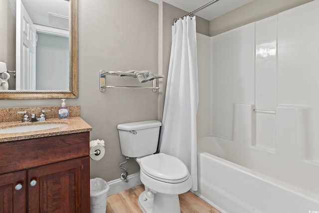 full bathroom featuring hardwood / wood-style flooring, vanity, toilet, and shower / tub combo with curtain