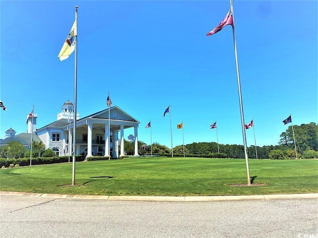 view of home's community with a yard