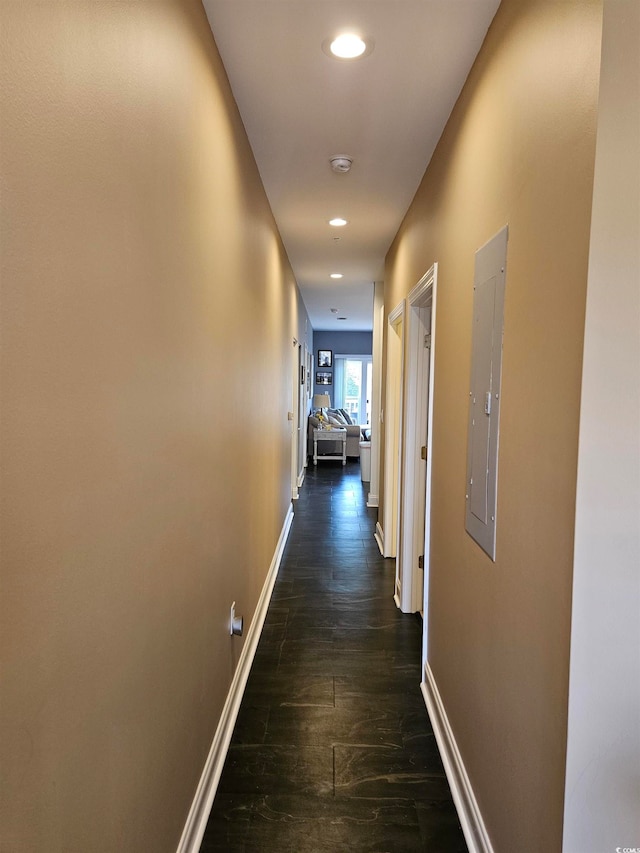 hallway with electric panel and dark wood-type flooring