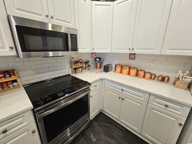 kitchen featuring white cabinets, stainless steel appliances, and tasteful backsplash