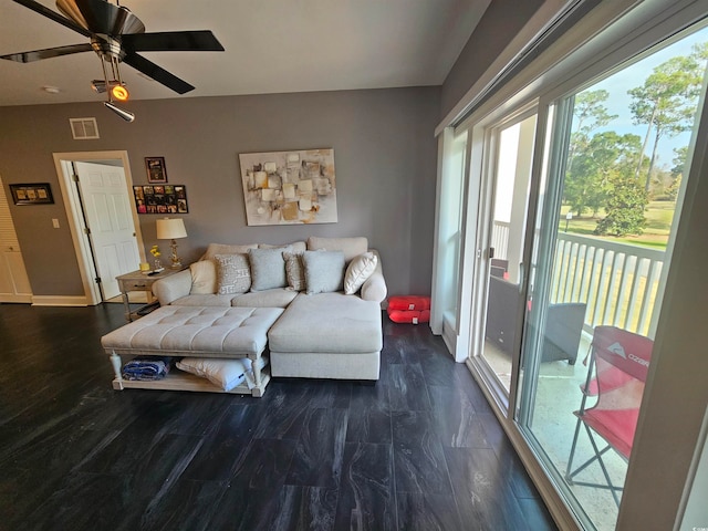 living room featuring ceiling fan and dark hardwood / wood-style flooring