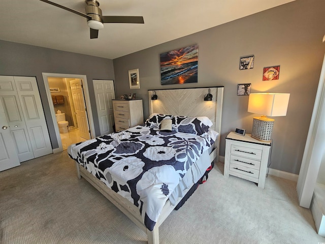 bedroom with ensuite bath, ceiling fan, a closet, and light carpet