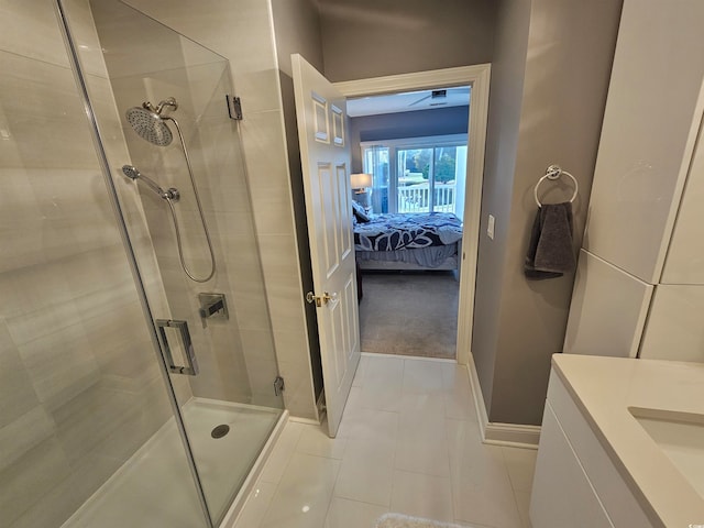 bathroom with tile patterned flooring, ceiling fan, and a shower with door