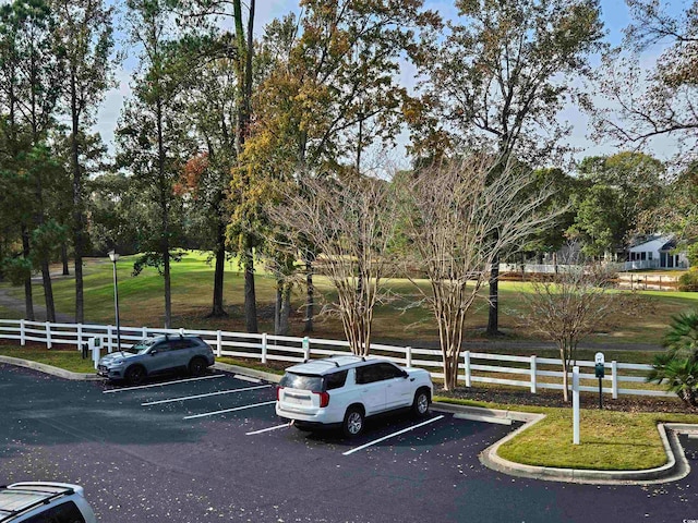 view of parking featuring a yard