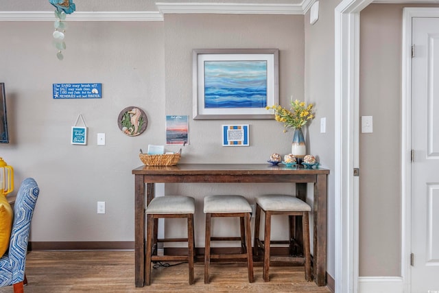 interior details featuring wood-type flooring and crown molding